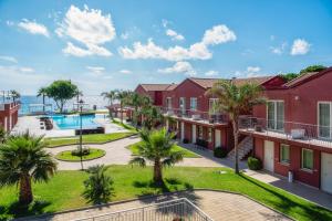 an aerial view of a resort with a pool and palm trees at Hotel Valeria Del Mar in Belvedere Marittimo