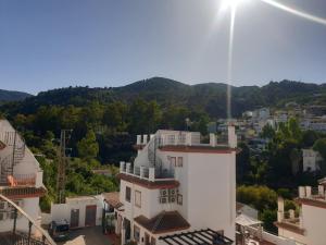 a white building with a view of a city at El Burré in Tolox