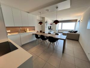 a kitchen with a table and chairs in a room at AMAZING Beach View Apartment type 28 in Ostend