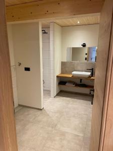 a bathroom with a sink and a mirror at Bummler Hof Allgäu in Legau