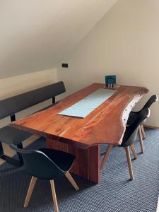 a wooden table in a room with two chairs at Bummler Hof Allgäu in Legau