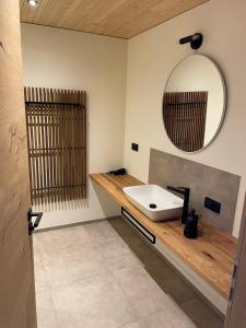 a bathroom with a sink and a mirror at Bummler Hof Allgäu in Legau