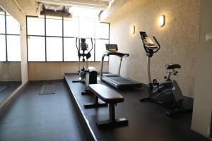 a gym with treadmills and exercise equipment in a room at Best Level Hotel in Jeddah