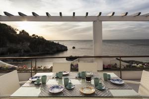 a table on a balcony with a view of the ocean at Ischia Blu Resort in Ischia
