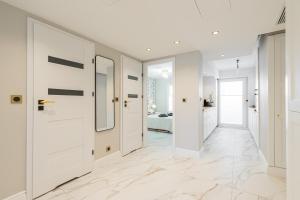 a hallway with white doors and a bedroom at St George in Antibes
