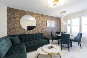 a living room with a green couch and a table at St George in Antibes