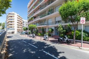 a street with three scooters parked in front of a building at St George in Antibes