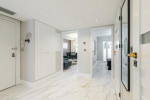 a hallway with white walls and white floors and a door at St George in Antibes