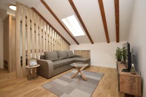 a living room with a couch and a table at Studio apartment Art Zone II in Podgorica