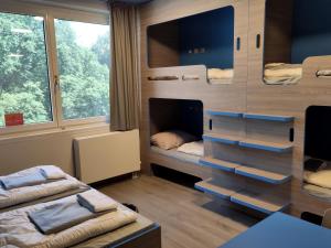 a room with two bunk beds and a table at Jugendherberge München City in Munich