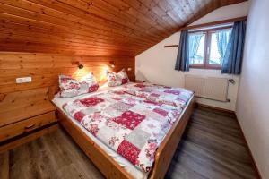 a bedroom with a bed in a wooden room at Landhaus Braun in Mittenwald