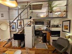 a loft apartment with a staircase and a desk at uniquechambre Gdynia in Gdynia