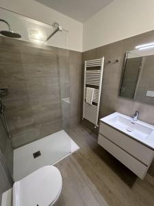 a bathroom with a toilet and a sink and a shower at Resort le Vele Suites and Apartments in Domaso