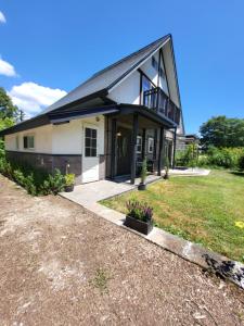 a house with a gambrel roof at Hakuba Powder Cottage in Hakuba