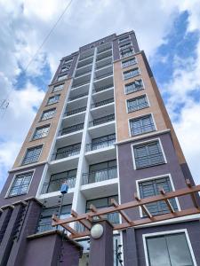 a tall building with many windows on it at Egoli Premiere Serviced Apartments by Nest & Nomad in Nairobi