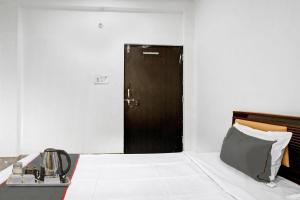 a bedroom with a large bed with a door in it at Flagship Arman Residency & Guest House in Kakarmatha