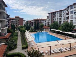 an overhead view of a swimming pool with chairs and buildings at private apartments in Apolon in Ravda