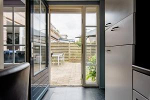 a kitchen with a door leading to a patio at Sky Villa in Bergschenhoek