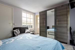 a bedroom with a large bed with a large sliding door at Sky Villa in Bergschenhoek