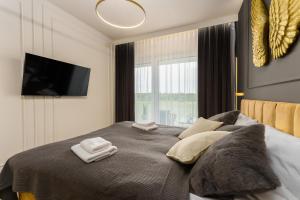 Ένα ή περισσότερα κρεβάτια σε δωμάτιο στο Apartament z basenem Polanki Aqua D306 +65 φωτογραφίες