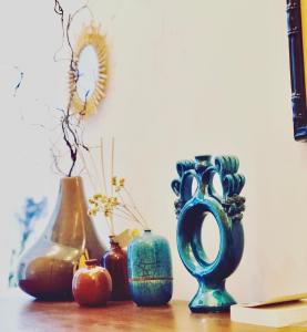 a group of vases sitting on top of a table at TigellioTre Bed and Breakfast in Cagliari