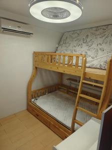 a bunk bed in a room with a ceiling at Best inn one oasis two bed room B2 524 in Carreta