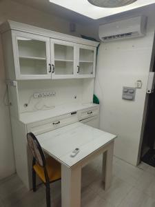 a white desk and a table in a room at Best inn one oasis two bed room B2 524 in Carreta