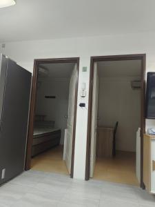 two open doors in a room with a bedroom at Best inn one oasis two bed room B2 524 in Carreta +11 photos