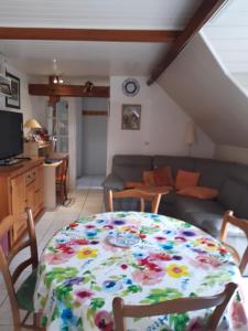 a table with a flower pattern on it in a living room at 3 Rue Vicaire in Contalmaison