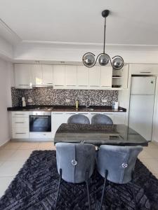a kitchen with a table and two chairs at The Valley 2 bedroom Apartment in Side
