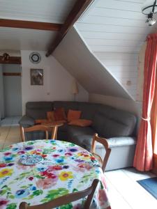 a living room with a table and a couch at 3 Rue Vicaire in Contalmaison