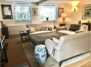 a living room with two couches and a table at Spring Cottage in Chipping Norton