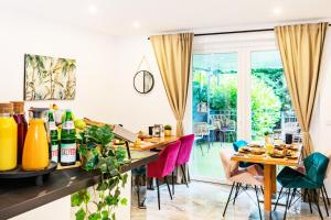a dining room with a table and colorful chairs at Hotel Fürst Garden in Dortmund