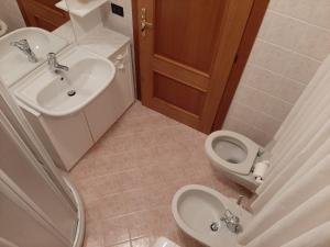 a bathroom with a sink and a toilet at Casa Ilaria in Campolongo +7 photos