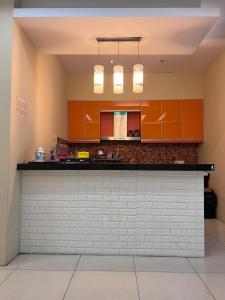 a kitchen with orange cabinets and a counter top at BANGI BUSINESS Hotel in Kampong Sungai Ramal Dalam