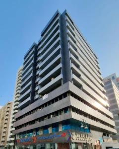 a tall building with a blue sky in the background at Dinar apartments - twin bed in Abu Dhabi