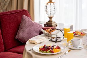 a table with a plate of breakfast food on it at InterContinental - Kyiv, an IHG Hotel in Kyiv