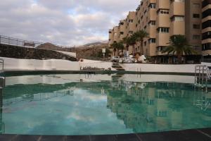 una gran piscina de agua frente a algunos edificios en Beachfront Seaview Oasis, en Tabaiba