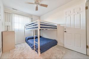 a bedroom with a bunk bed and a ceiling fan at New Ocean Front Couples Family Retreat Close2AC in Brigantine