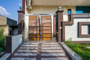 an entrance to a house with a glass door at Blue Moon Inn in Greater Noida