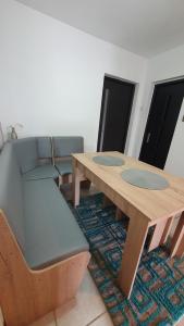 a table and a couch and a wooden table and chairs at Cazare la fermă in Galeşu +198 photos