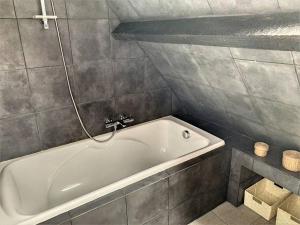 a bathroom with a white bath tub in a room at Le Odette - Campagne chic in Jaux +11 photos