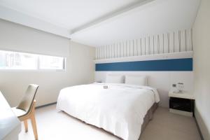 Postel nebo postele na pokoji v ubytování Dandy Hotel - Tianmu Branch