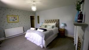 una camera con un grande letto di The White Lion at Wicken a Milton Keynes