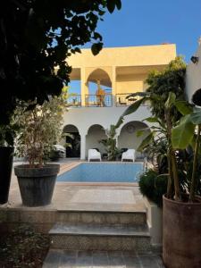 a house with a swimming pool in front of it at VILLA NAKHLA in Chouiter