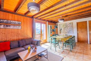 a living room with a couch and a table at Chalet L'oréade in Manigod