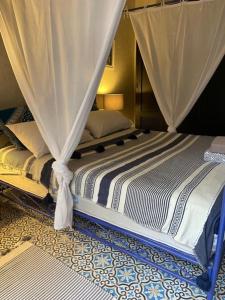 a bed with a canopy in a room at VILLA NAKHLA in Chouiter