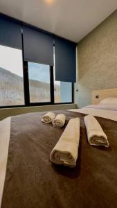 a hotel room with two towels on a bed at Twins in Tbilisi City