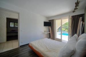 een slaapkamer met een bed en uitzicht op een zwembad bij Private villa swimming pool hills Cannes in Vallauris
