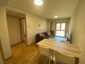 a living room with a table and a couch at Casa Ega in El Pueyo de Jaca